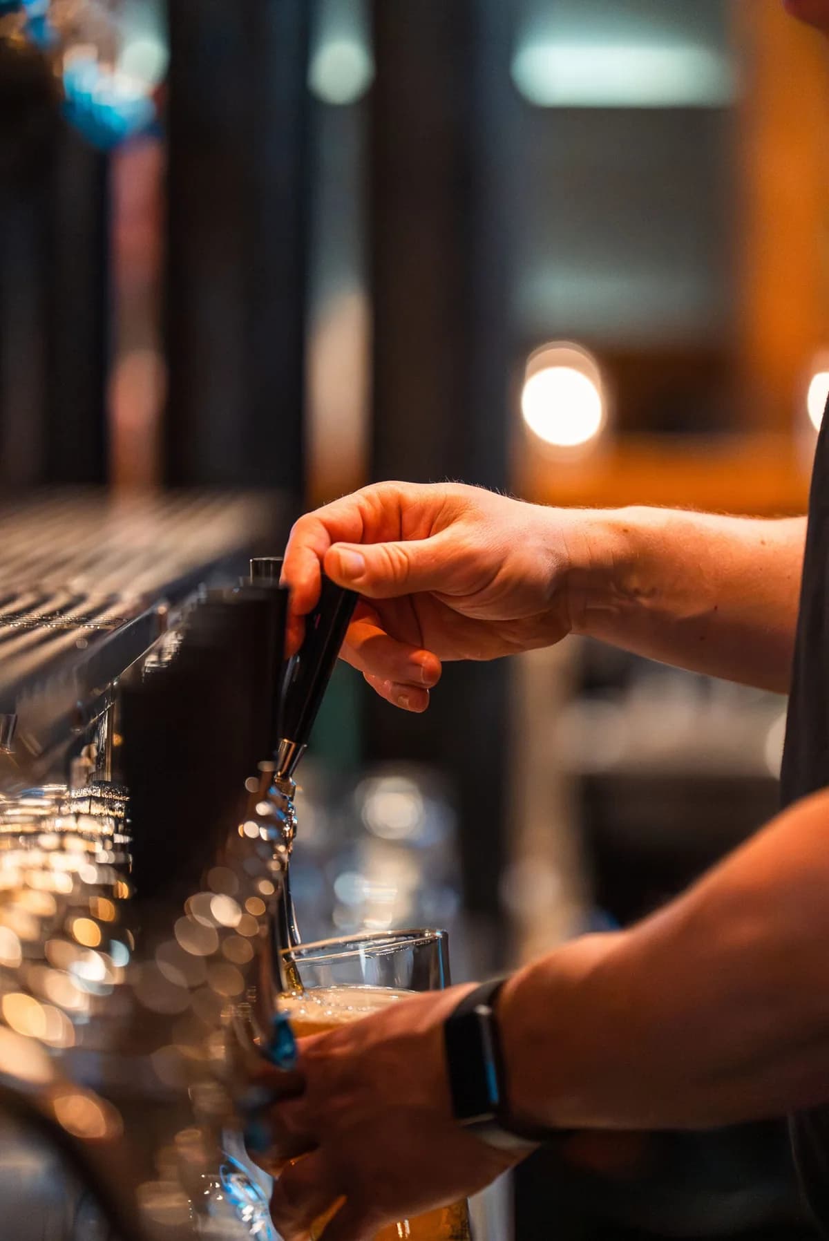 A bartender pouring a pint at Swan's